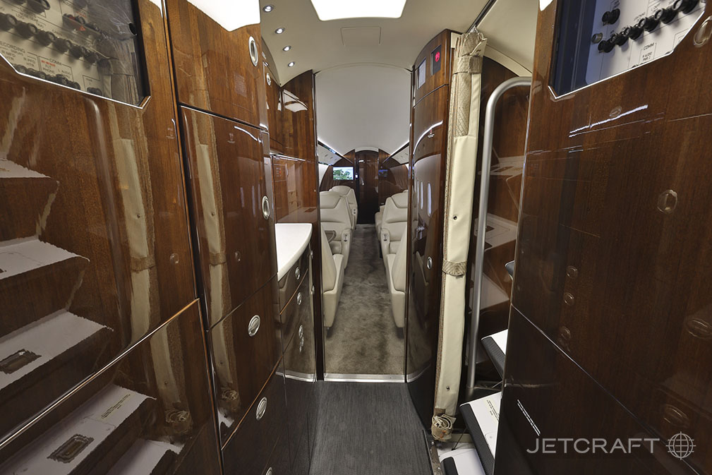 The interior of the Challenger aircraft features a galley and seating area.