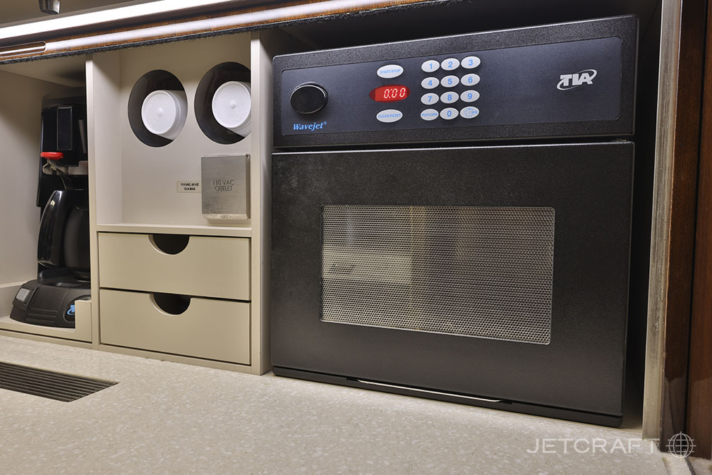 The interior of the Challenger aircraft features a microwave and coffee maker.